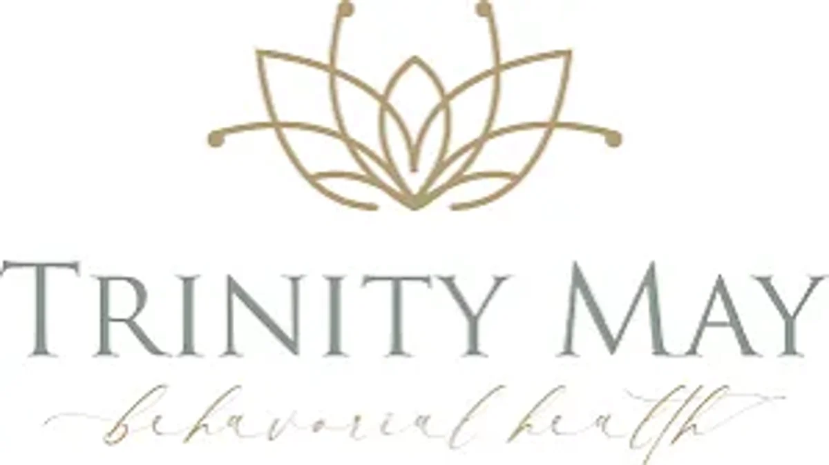 Trinity May Behavioral Health logo: a gold lotus mark above the practice name