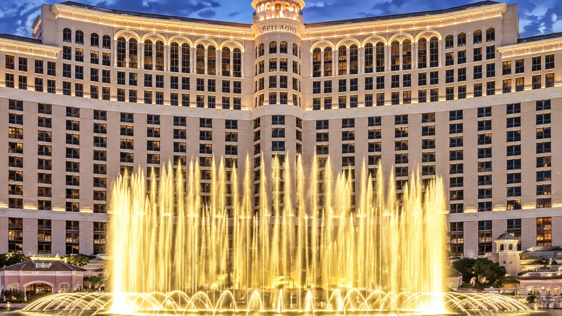 The Bellagio fountains illuminated in front of the resort at night